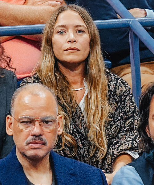 MaryKate Olsen watching a tennis match in a paisley scarf