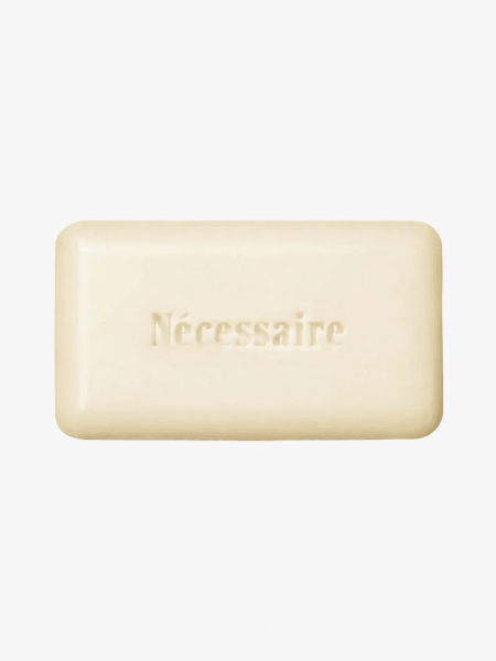 Nécessaire The Body Exfoliant Bar in branded component on a light gray background